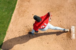 Teenage baseball pitcher throwing ball