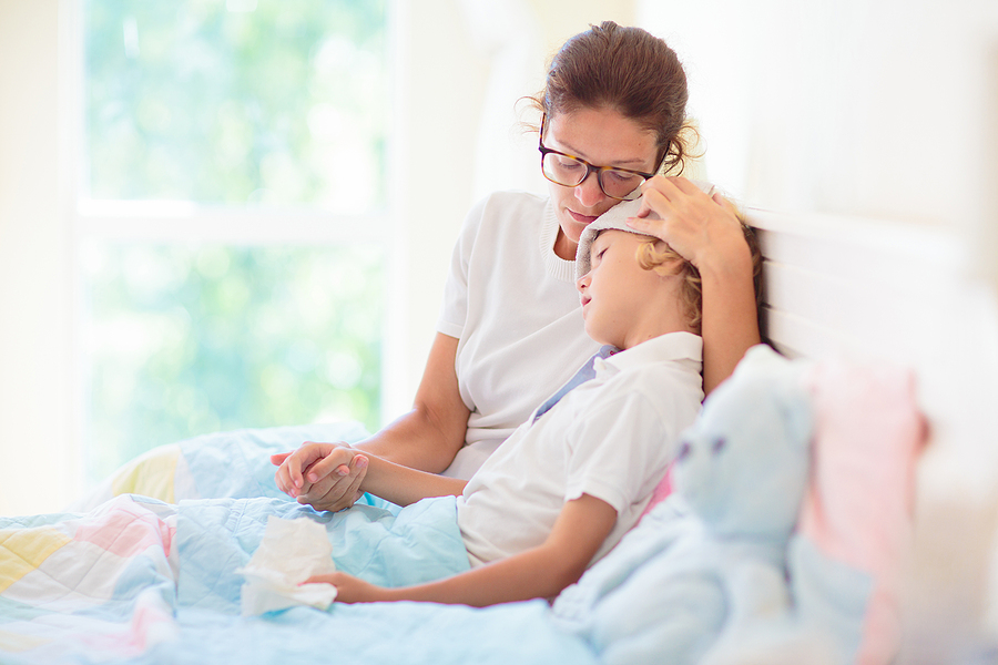 A child sick with RSV is comforted by a parent
