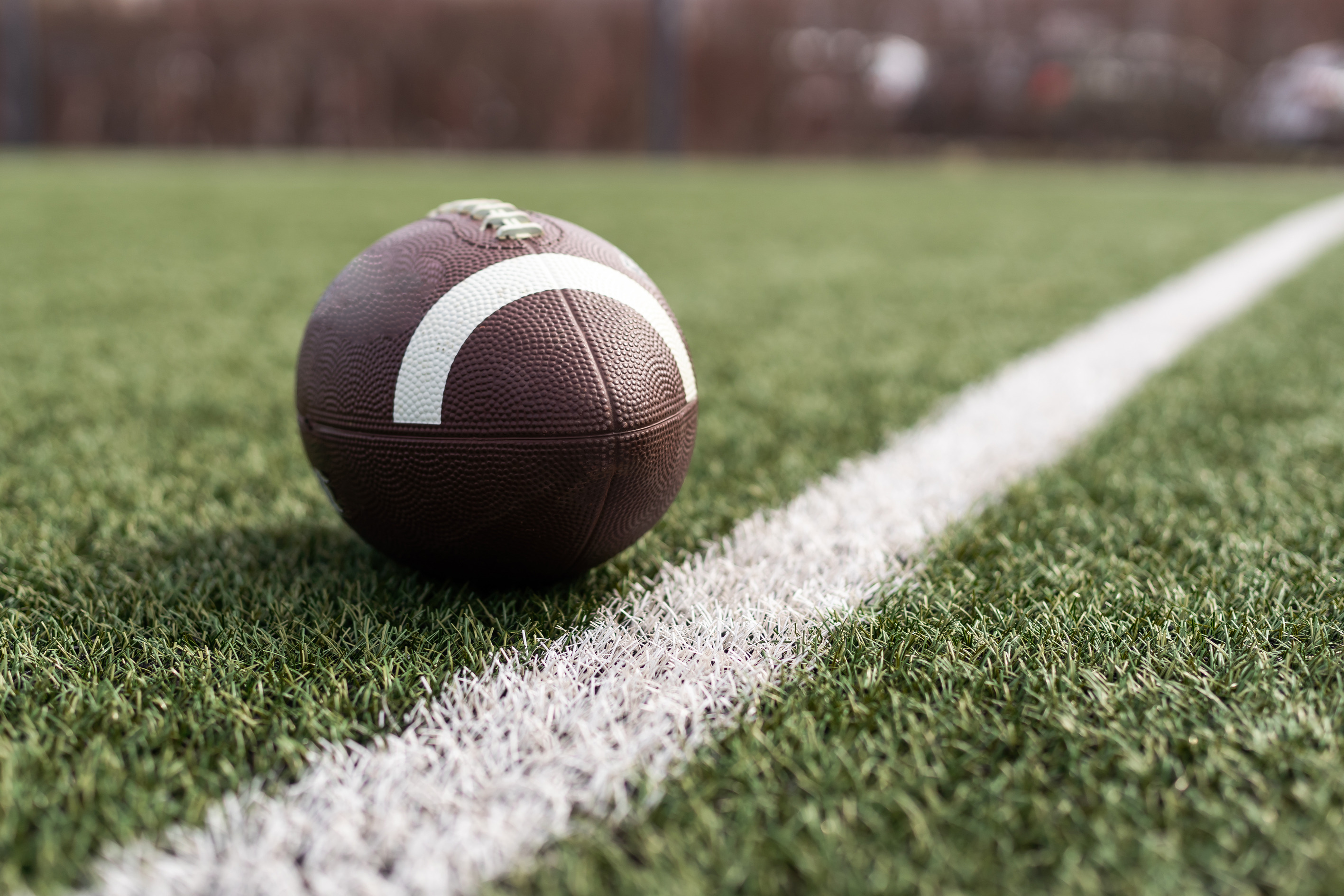 Picture of a football on a field.