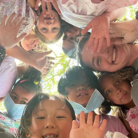 Kids happily huddling over a camera