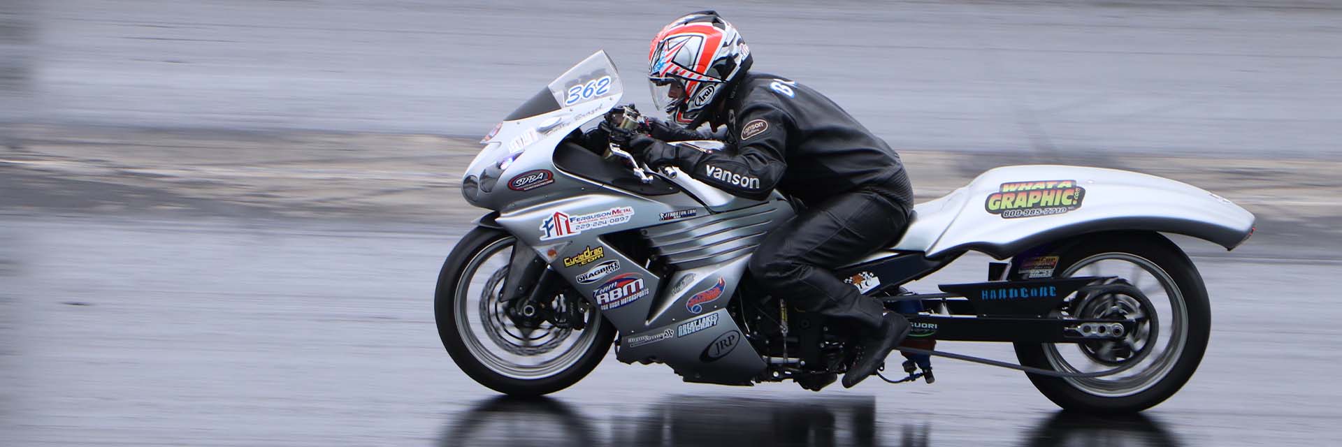 Motorcycle 362 on the dragracing strip in action moving down the track.