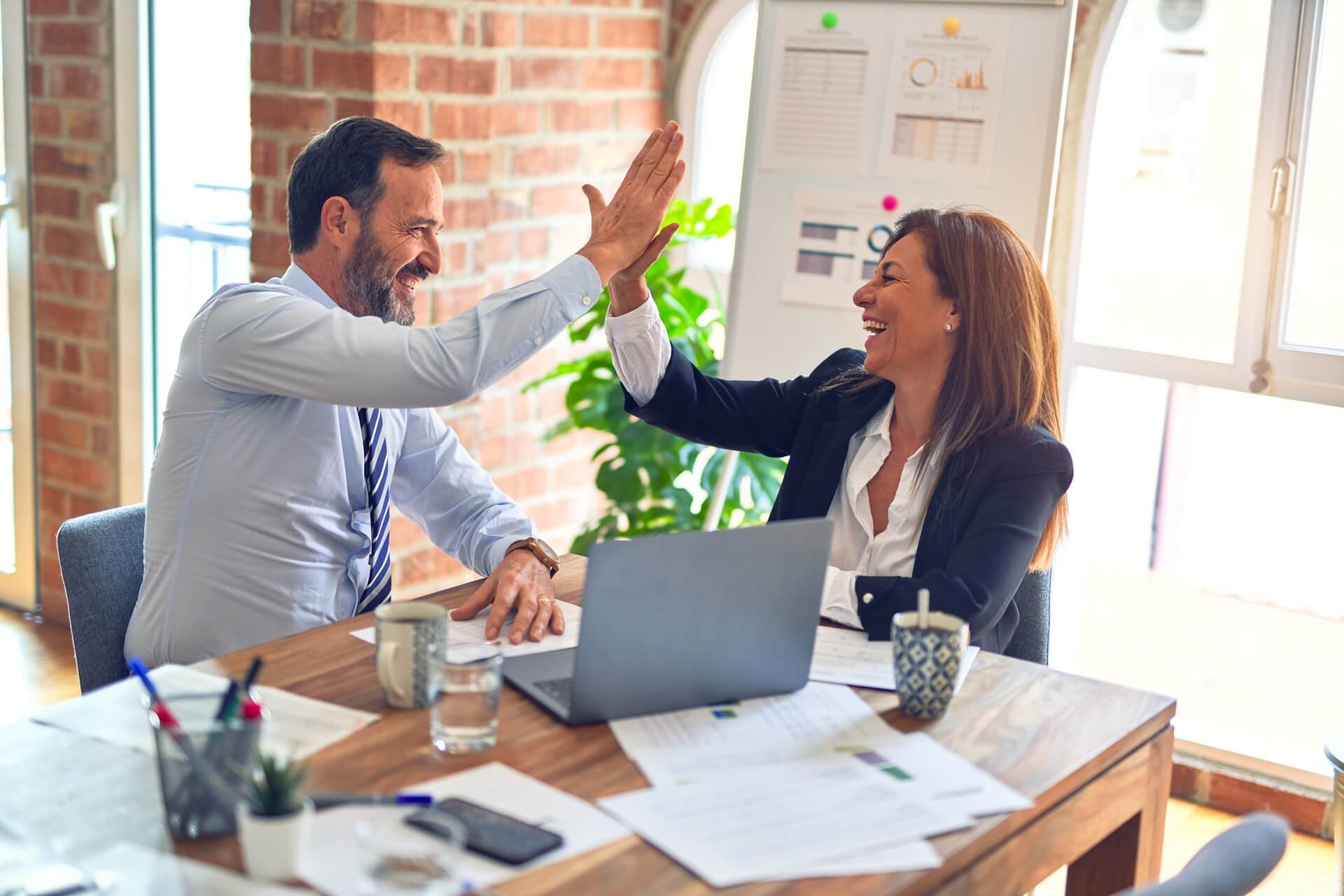 high-five between two coworkers 