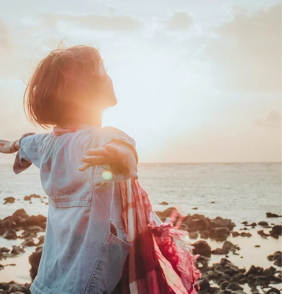 Woman open arms at beach