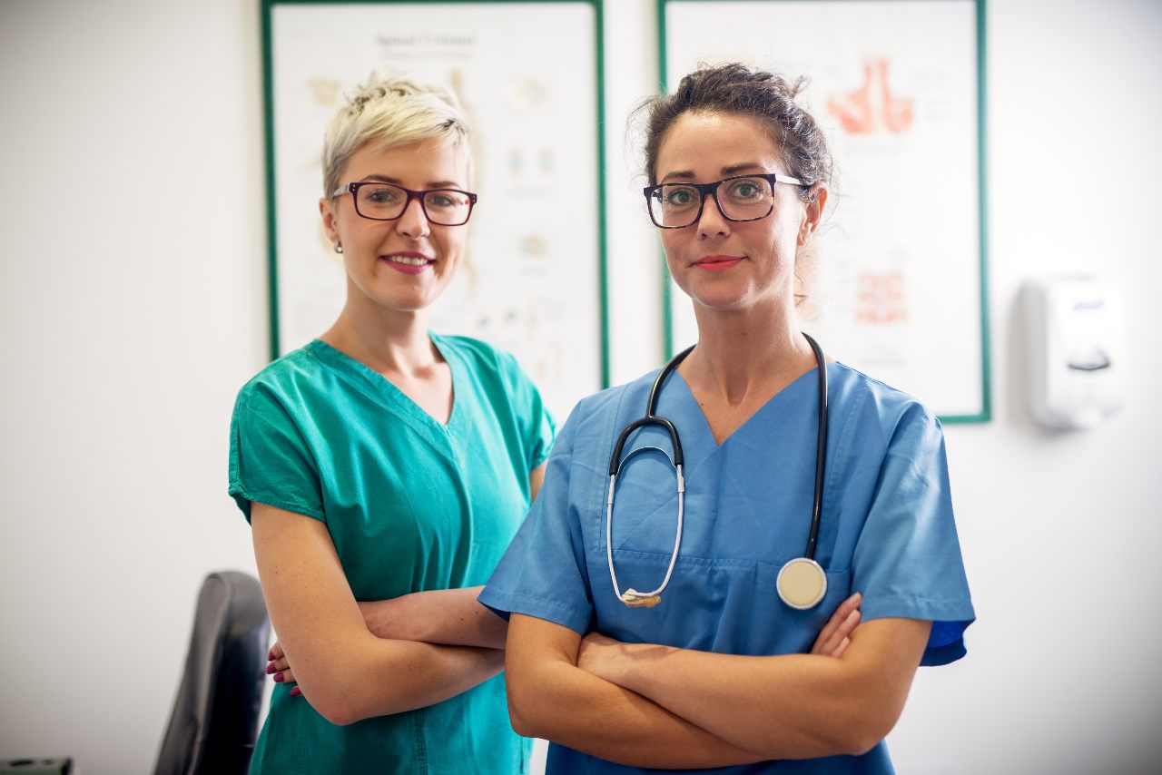 PCU nurse and PACU nurse standing side by side