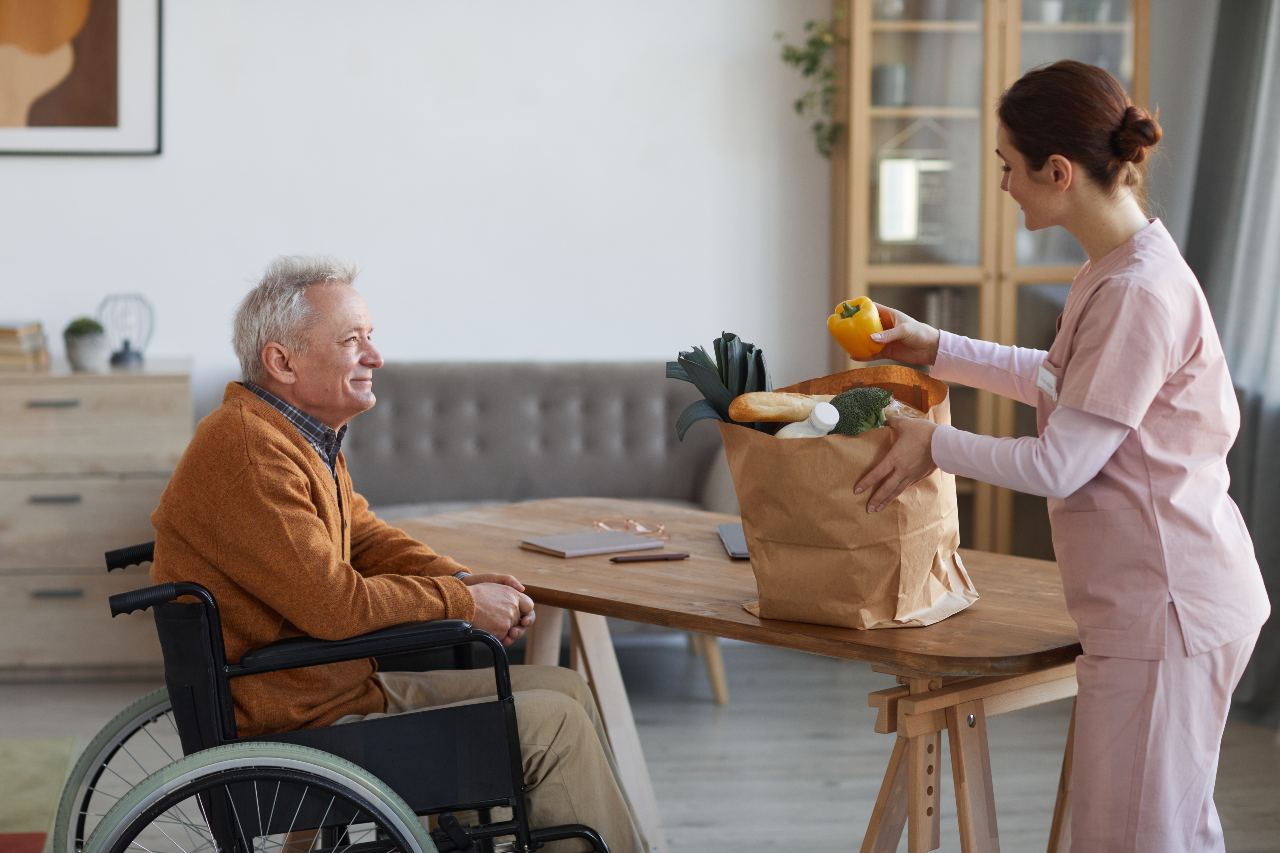 picture of a home health nurse delivery groceries to a patient