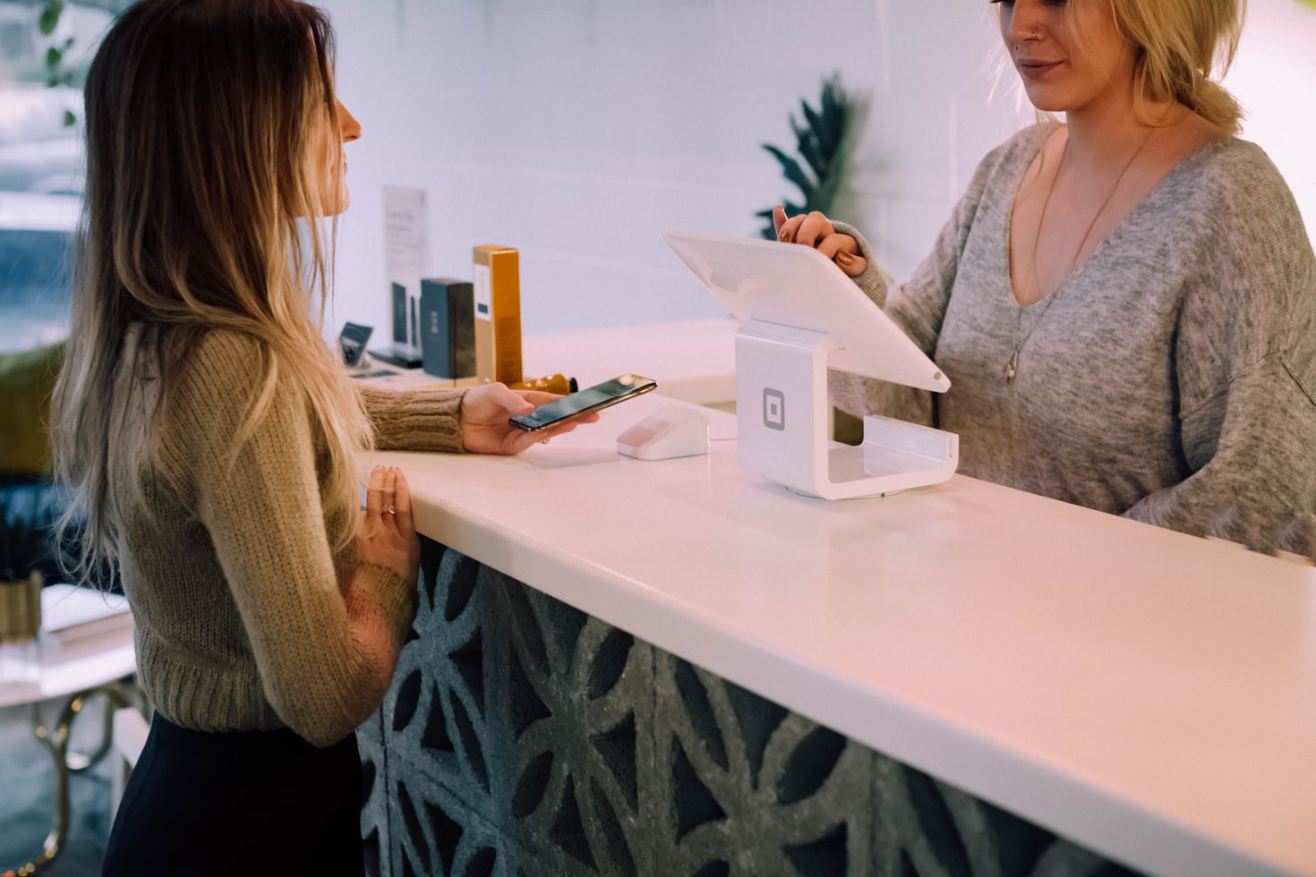 paying-woman-with-cellphone-at-counter