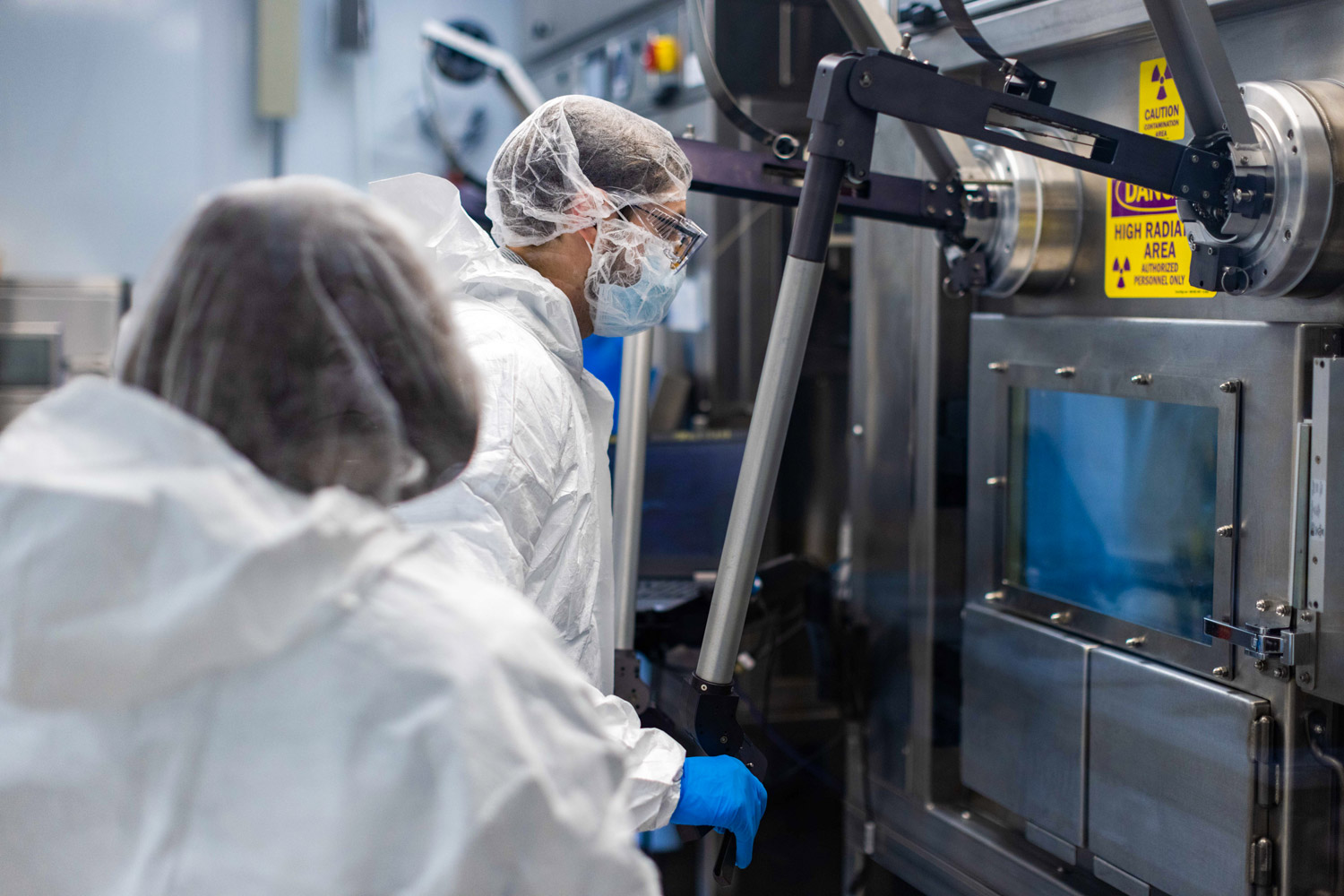 Employees wearing PPE working in a radioisotope production area