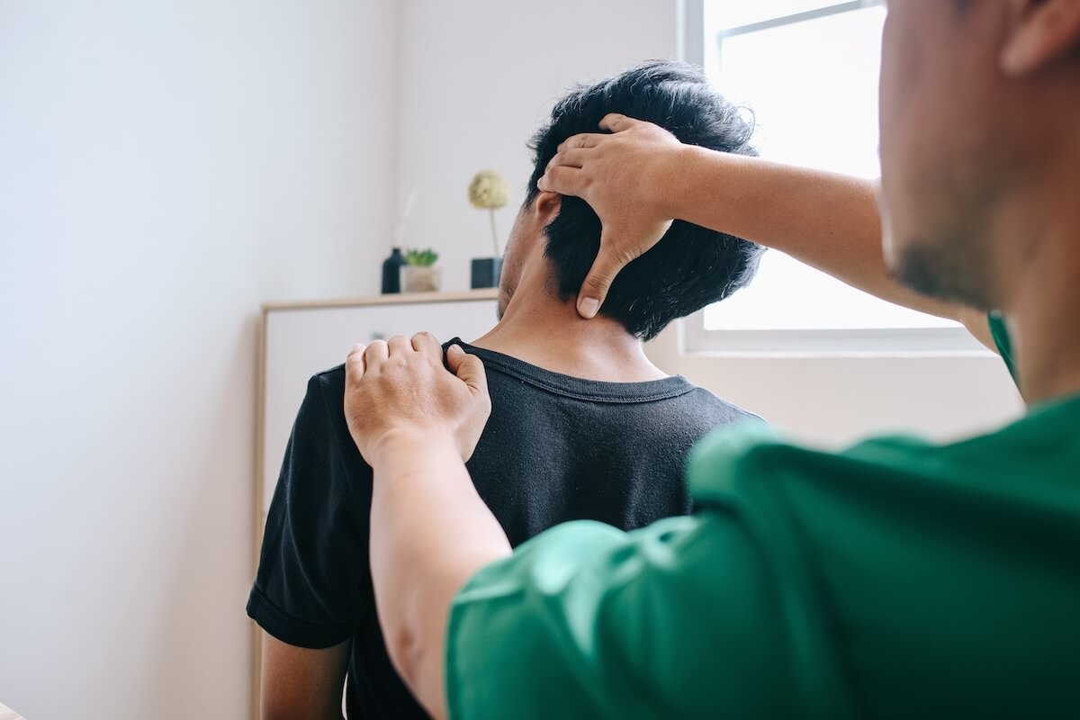 Sudden lump between neck and shoulder: therapist examining a patient