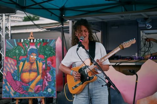 a woman playing a fender telecaster and singing