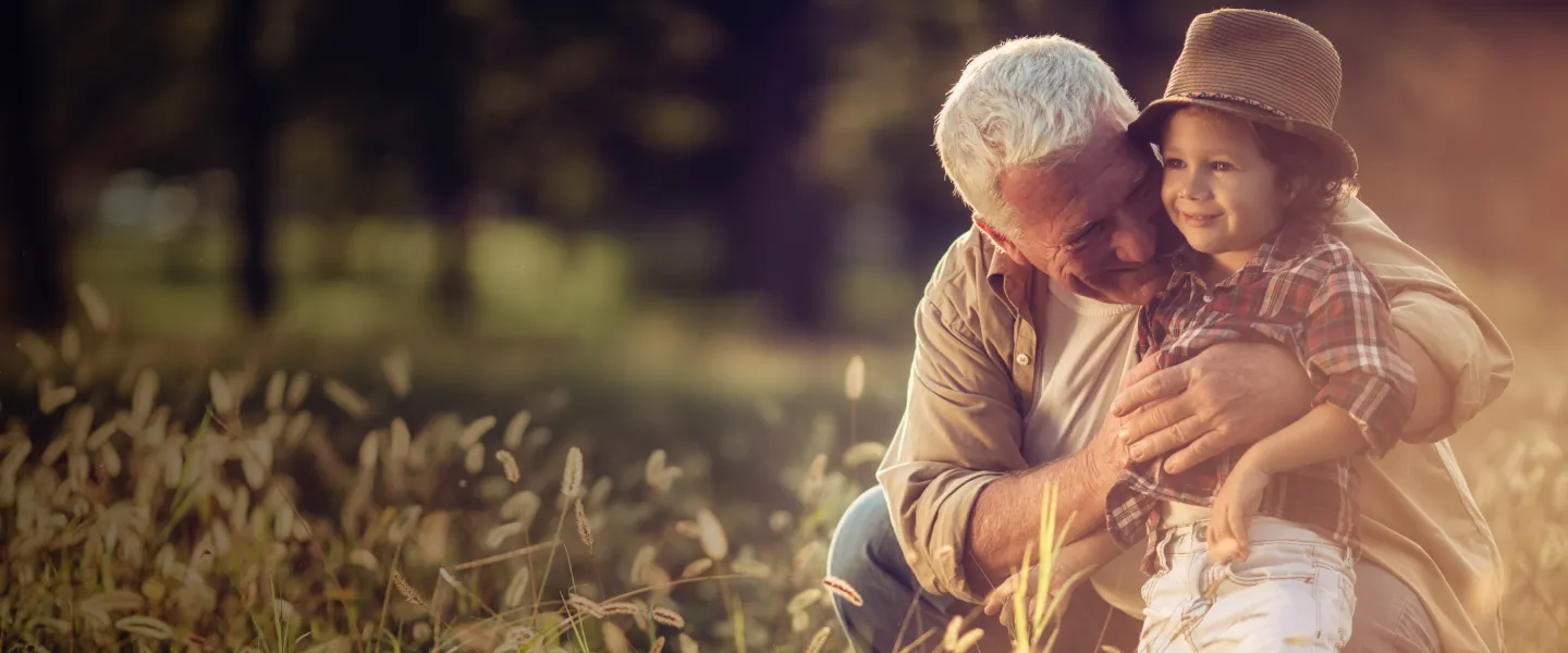 grandfather with child in field - hero