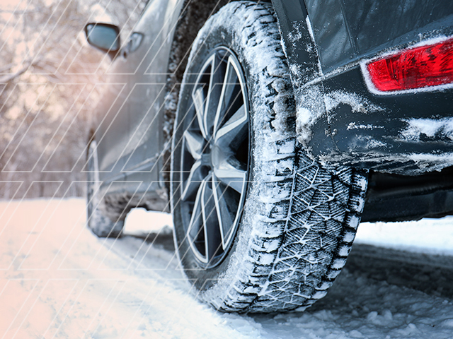A used car driving through snowy conditions