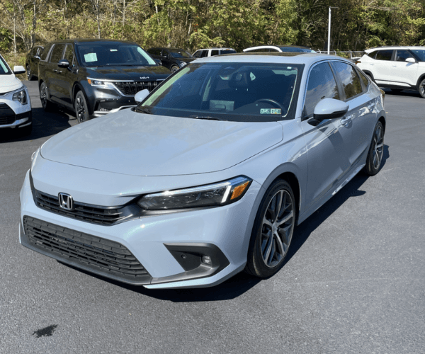 A light blue Honda Civic in a parking lot