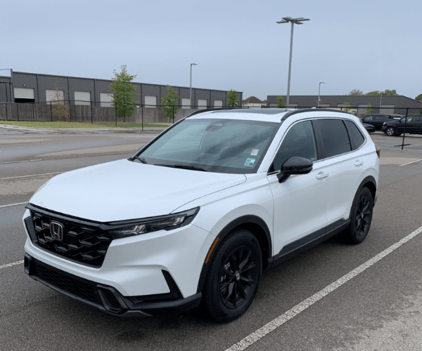 A used white Honda CR-V in a empty parking lot