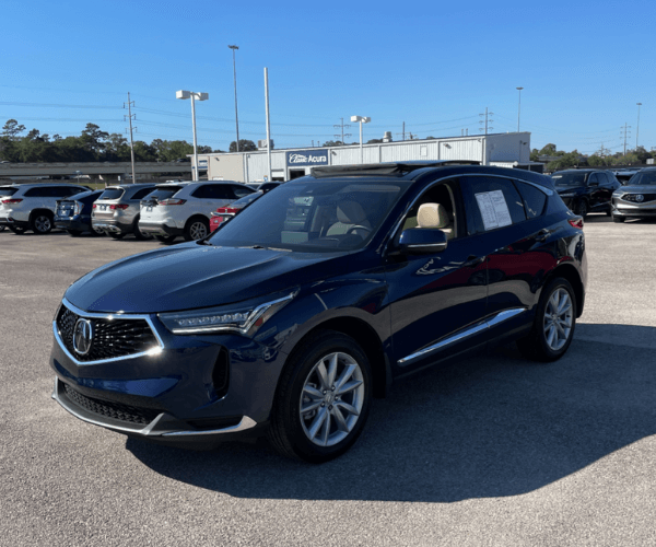 A used black Acura RDX in a dealer parking lot