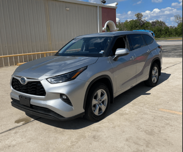 A used Toyota Highlander Hybrid in an empty parking lot