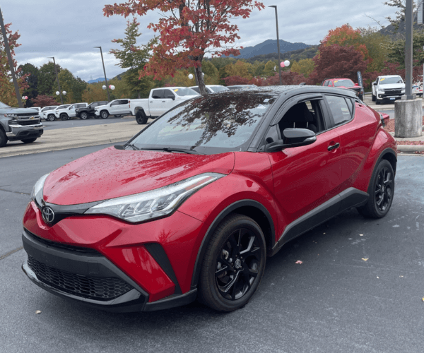 A red used Toyota C-HR in a parking lot