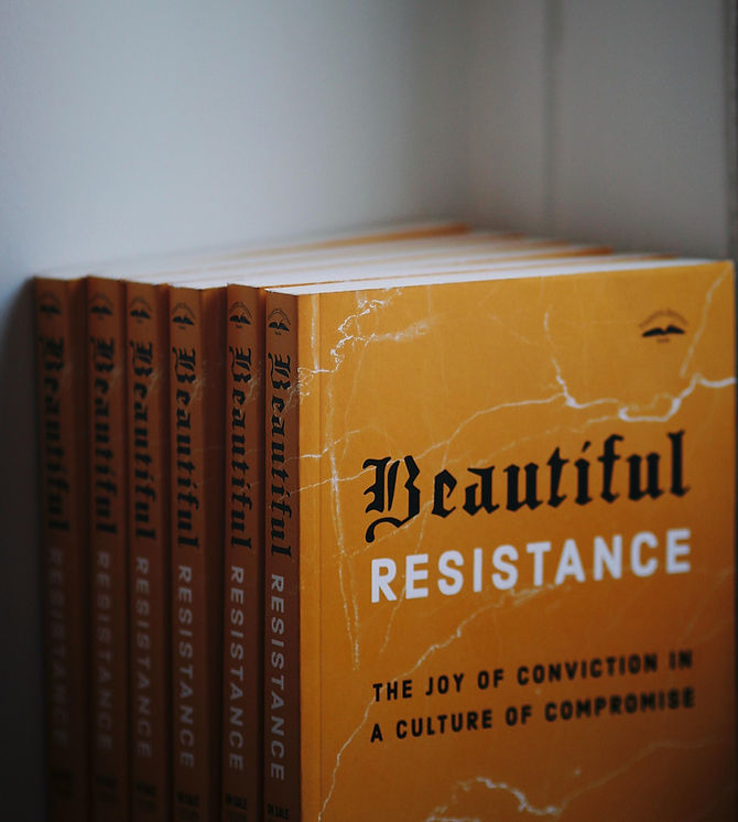 Stack of books with yellow background ready to ship. Book title is Beautiful Resistance by Jon Tyson and has a yellow background with a white marble effect. 