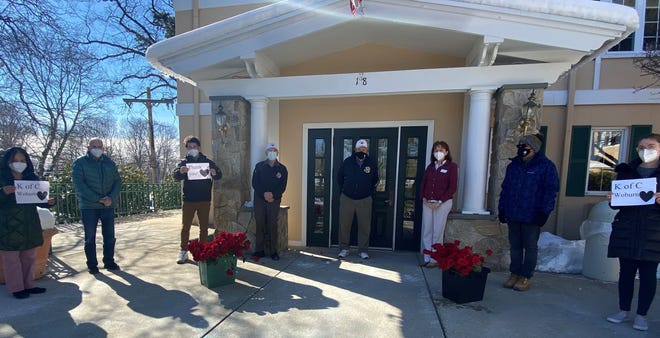 The Knights of Columbus deliver roses to the Woburn Nursing Center.