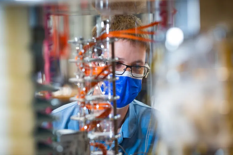 A test engineer works in SHINE’s manufacturing facility in Fitchburg, Wis.