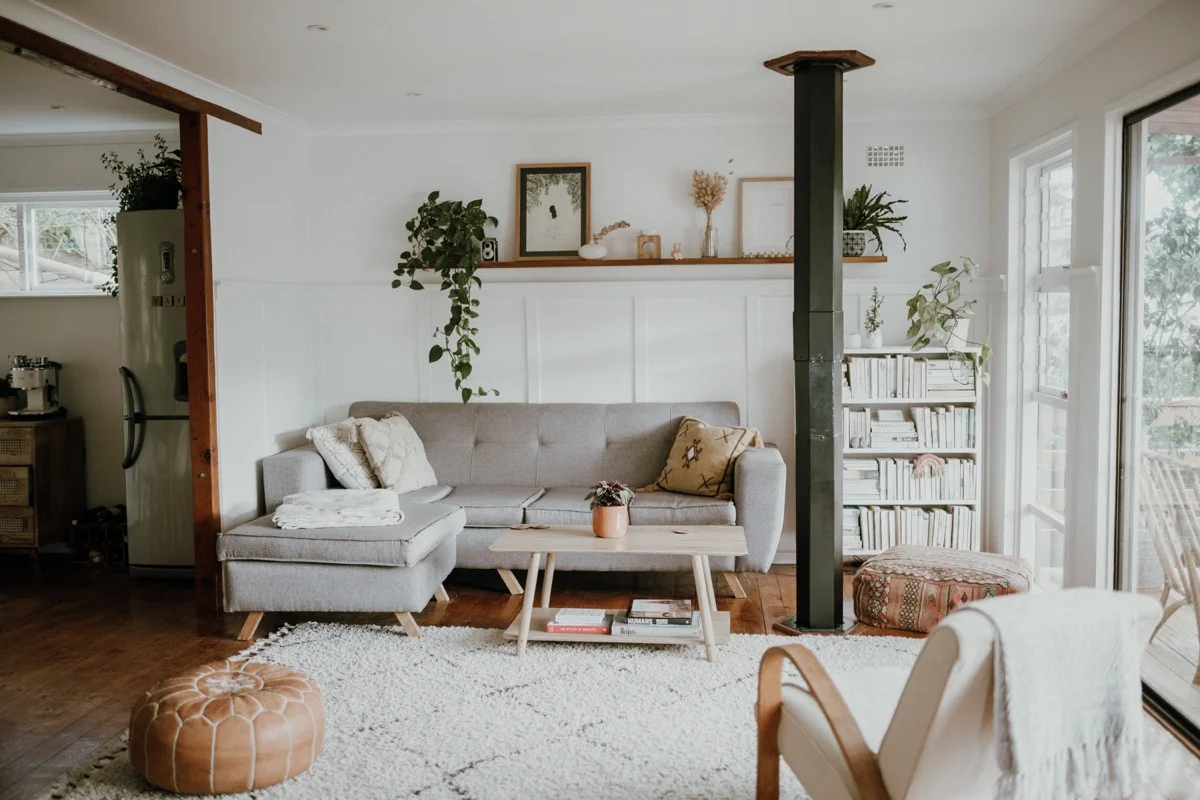 Living room with a grey couch by Taryn Elliott