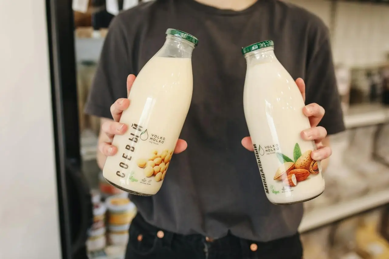 person-holding-bottles-with-milk