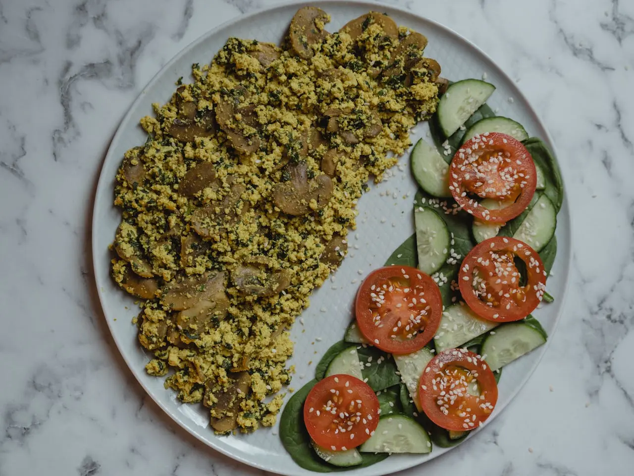 egg mushroom salad with cucumber and tomato on the side 