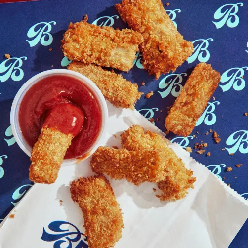 Cultivated chicken strips with red dipping sauce