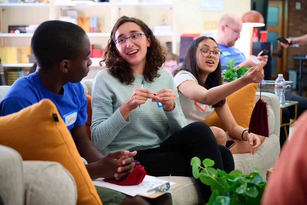 Students talking on a couch.
