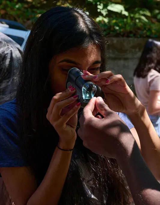 Atlas Fellow using a microscope