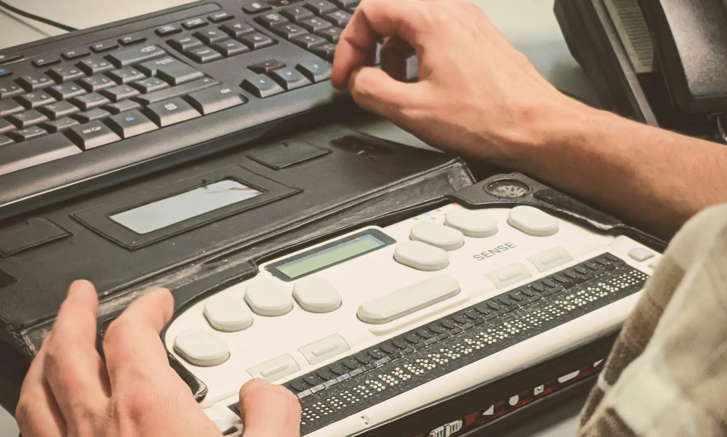 person typing on an accessible computer