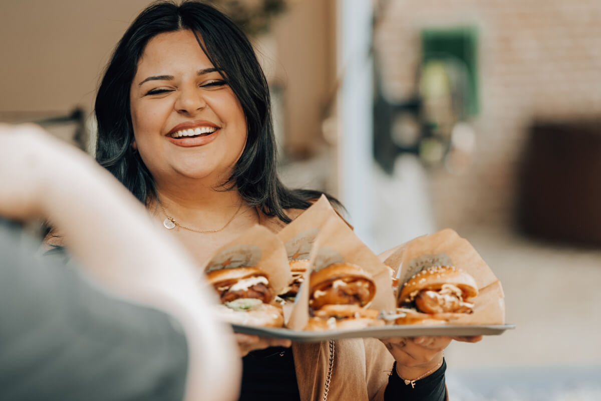 Frau mit Burgern von Street Quizine Foodtruck am Geburtstag