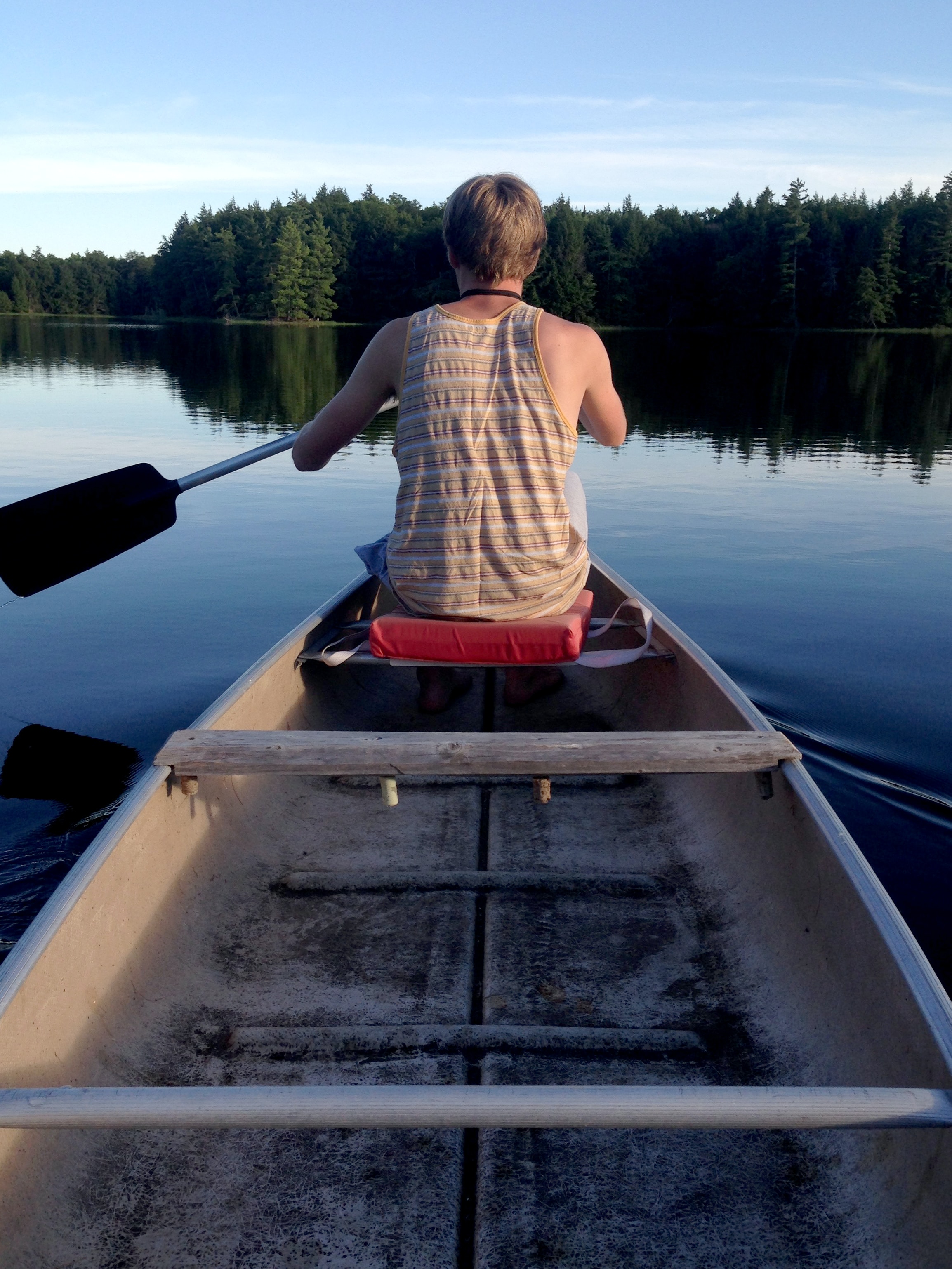 Boy paddling on lake in Sparta, Michigan 