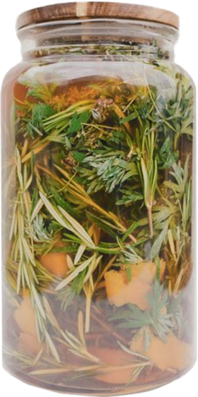 Glass jar filled with orange, herbs and botanicals 