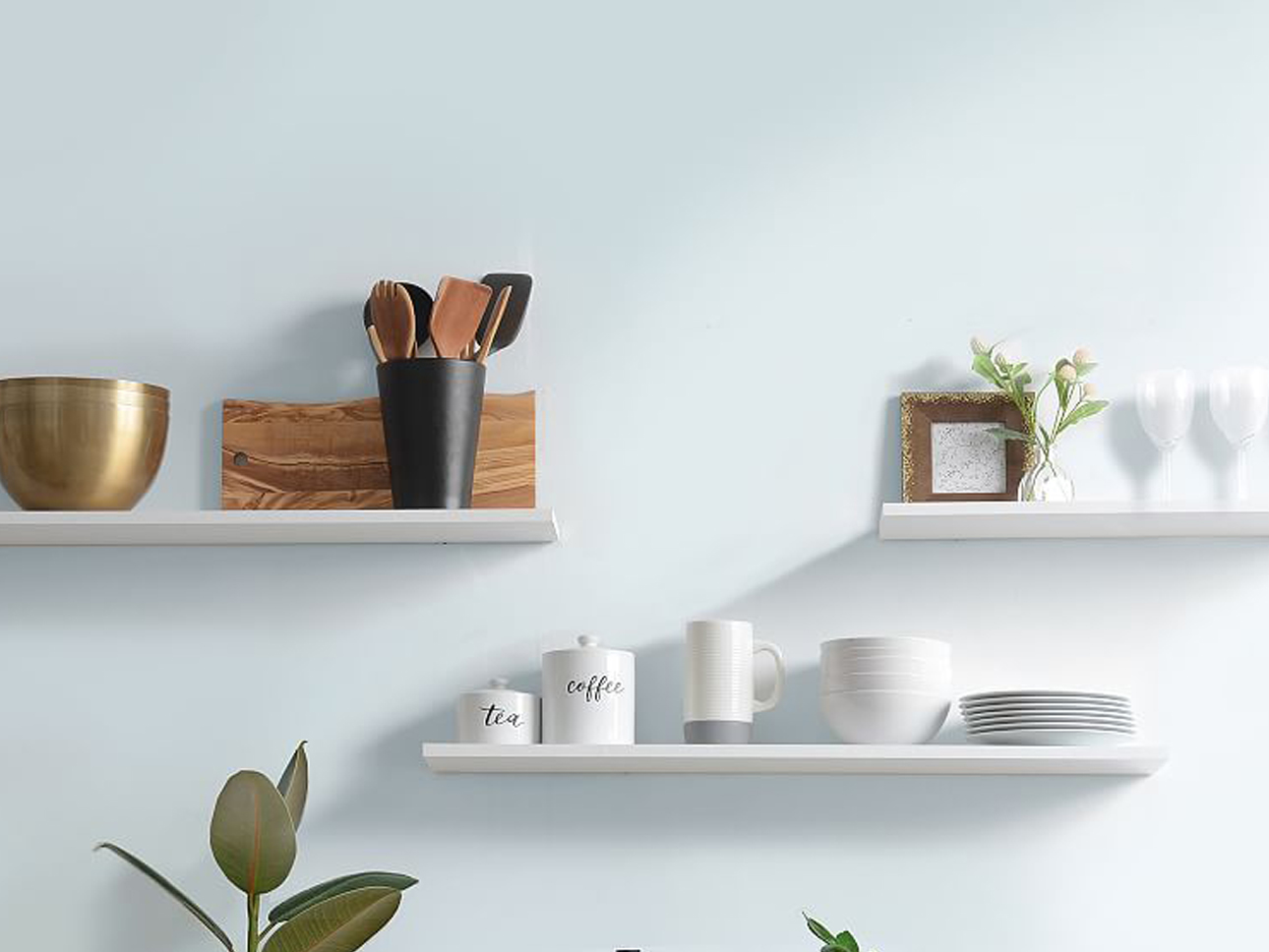 White floating shelves with plates on top.