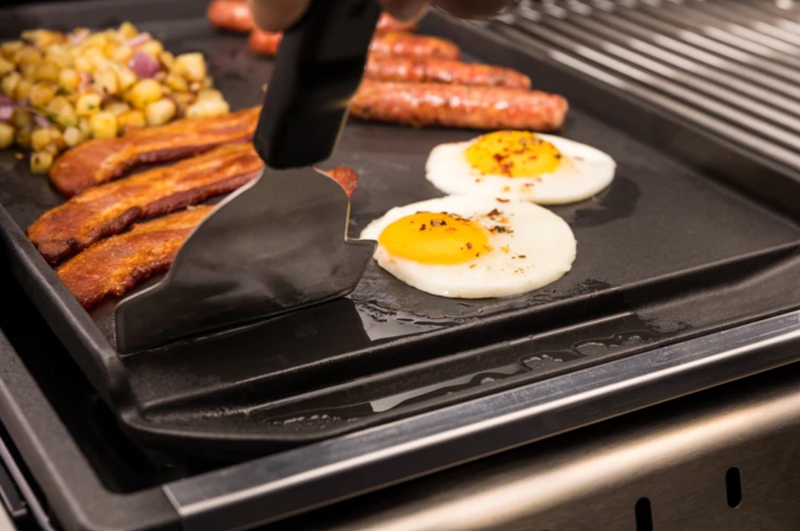 Stove top griddle making food. 