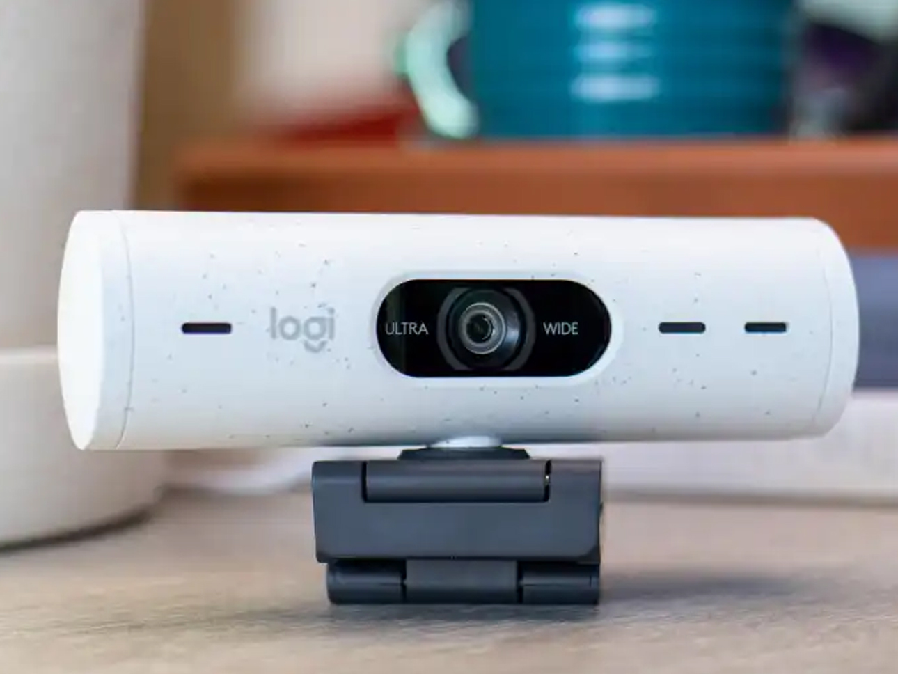 Logitech camera on a desk.