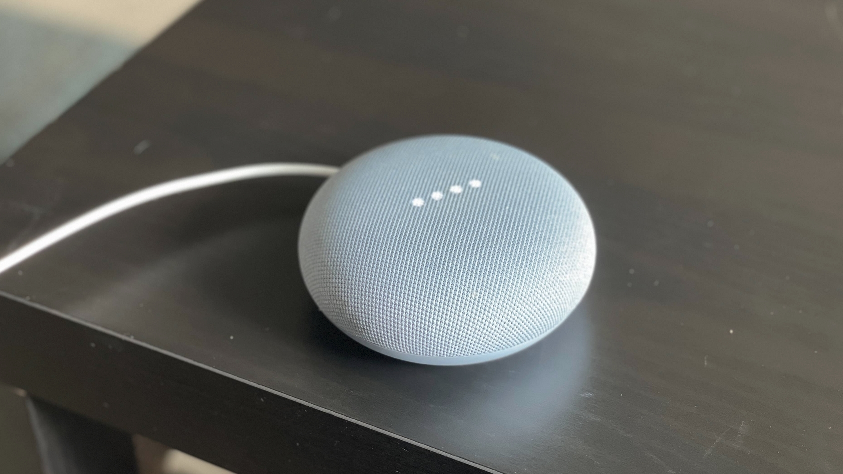 Google Nest Mini on a desk.