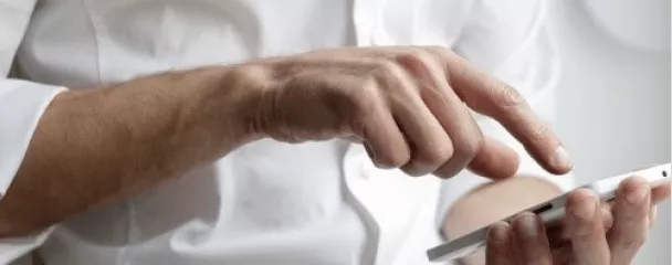 a close-up of hands holding a tablet