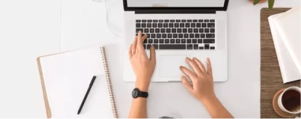 a person's hands on a laptop