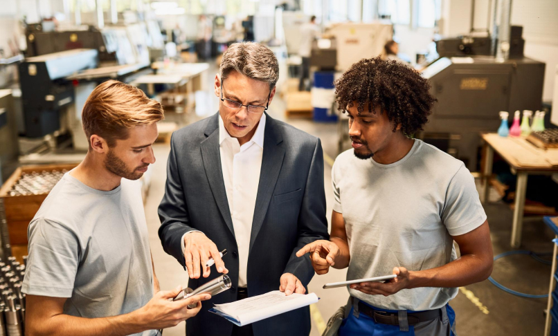 three person looking at a report