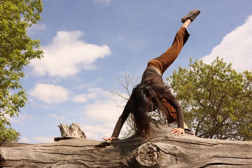 Person on concrete guardrail with leg extended