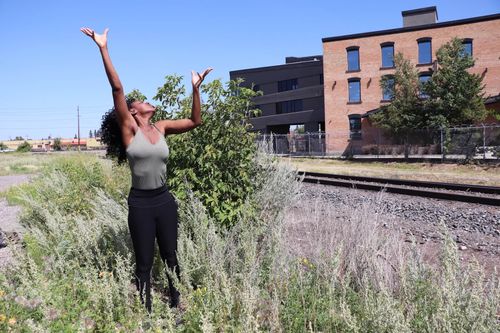 Person on concrete guardrail with leg extended