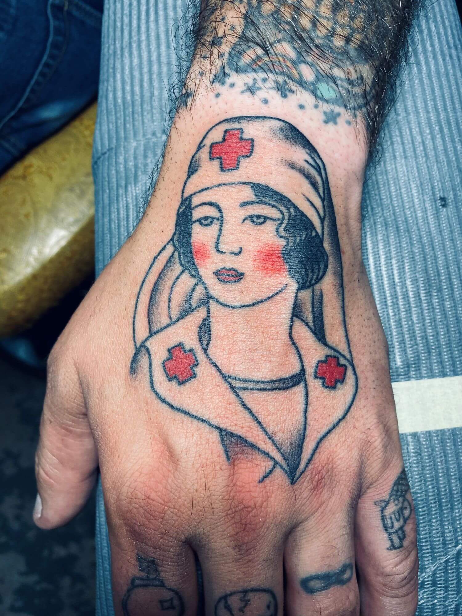 Traditional nurse hand tattoo by Joe Radnik at Saints and Sinners Tattoo.