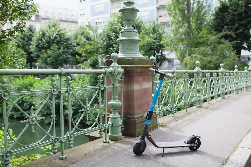 a scooter parked on the side of a bridge