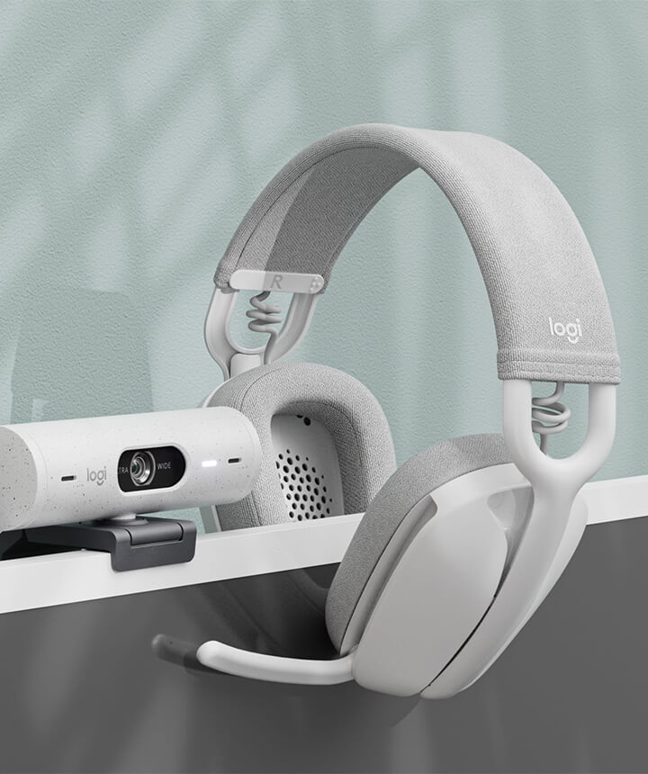 Logitech web camera and headset perched on top of a monitor