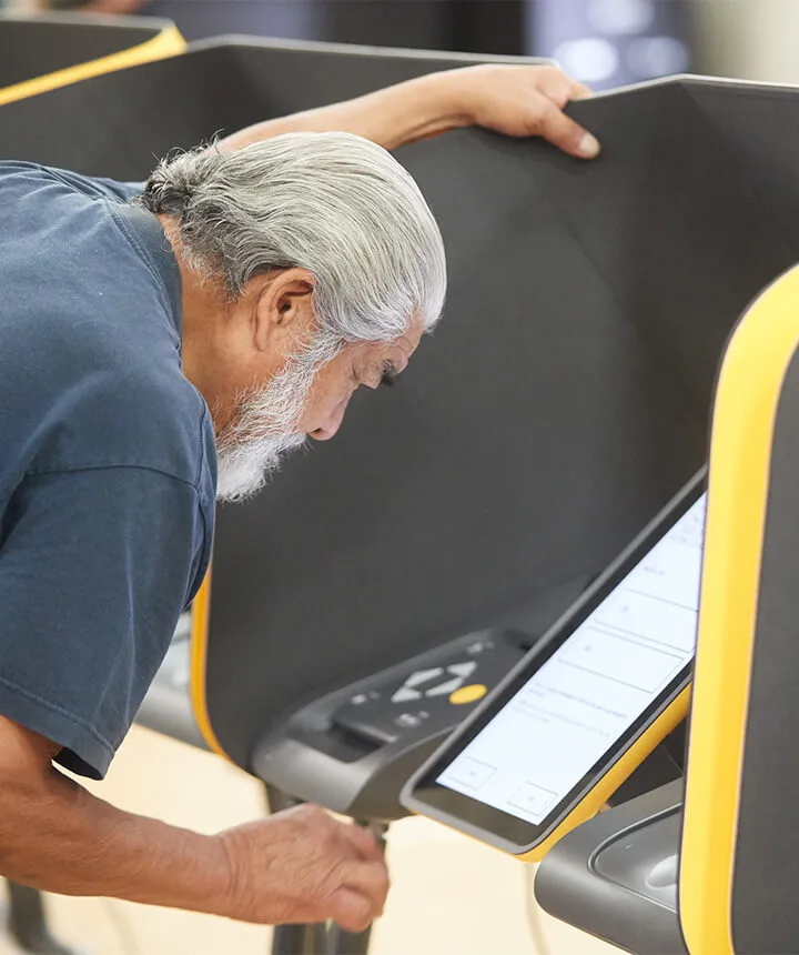 Man voting using a touchscreen display