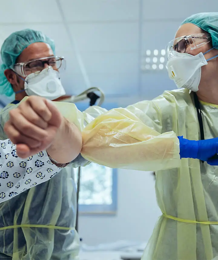 Healthcare workers bumping elbows