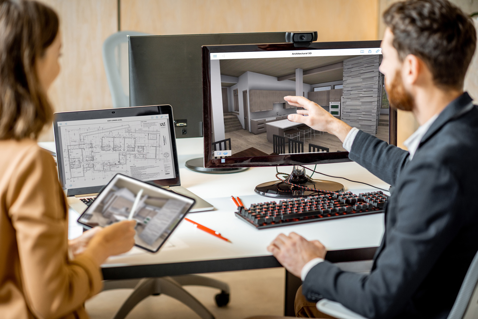 Two architects engaging in a project, utilizing multiple devices for collaborative work