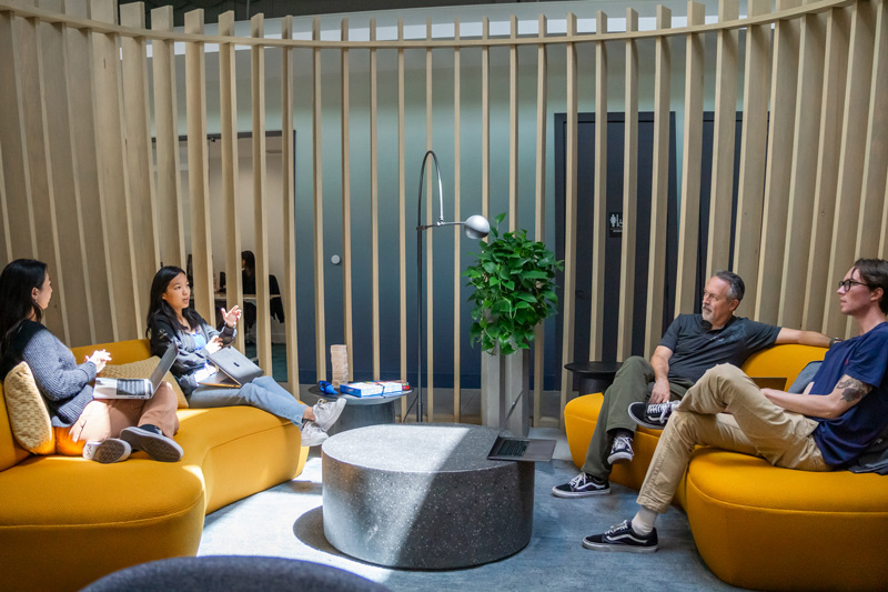 Team of Chargie employees gather in the lounge area inside the headquarters office to brainstorm strategies.