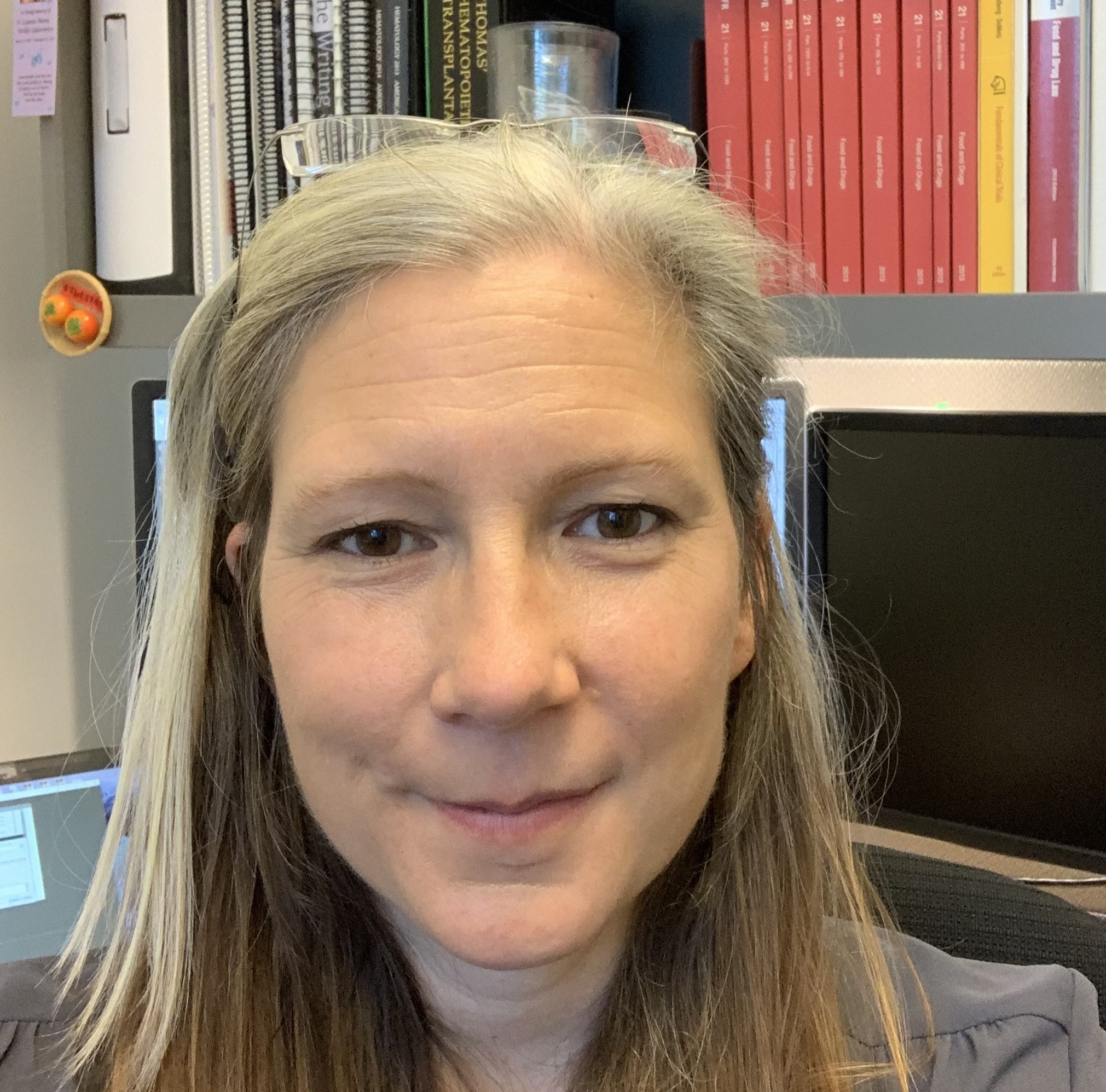 Dr. Kristin Baird, pictured with the Code of Federal Regulations in the ...